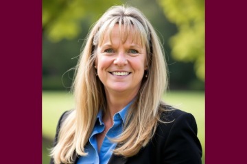 Headshot of Lori Irwin with trees behind her.