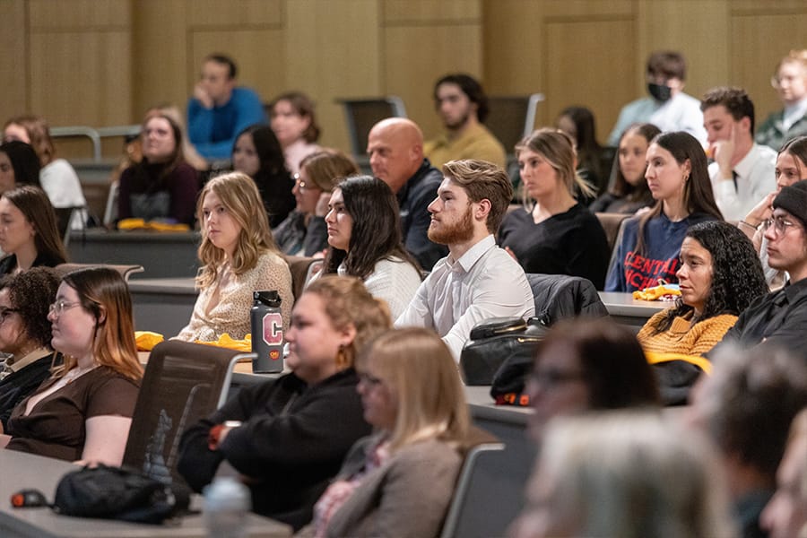 A group of students attend a presentation in the French Auditorium on campus.