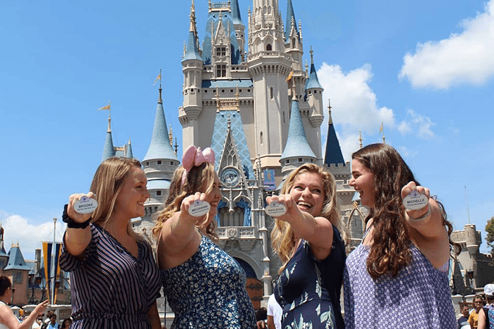 Four girls holding name badge 700 x 467 Four girls holding their Disney name badge