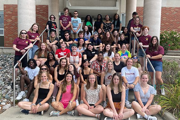 Rows of students from the Public Service Residential College pose on the steps to Anspach Hall.