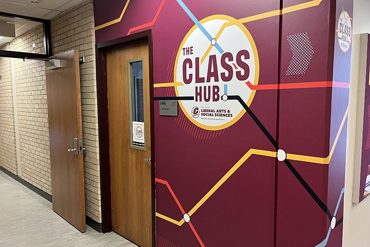 Entrance to the CLASS Hub with a maroon wall and colorful lines.