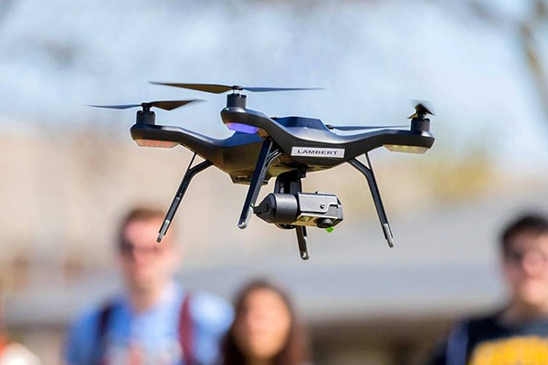 Students watching drone being flown.