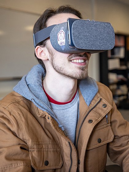 A student wearing a virtual reality headset.