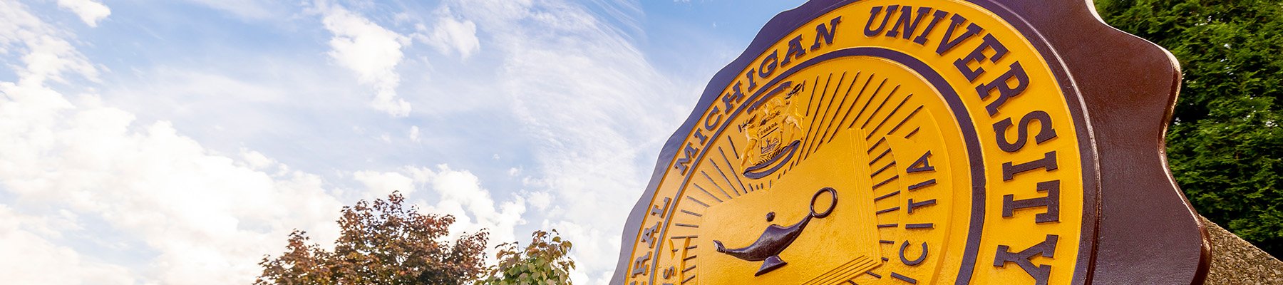 The CMU seal outside of Warriner Hall that says Central Michigan University.