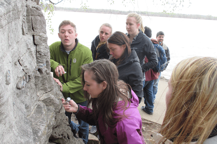 Geology students examining an outcropping.
