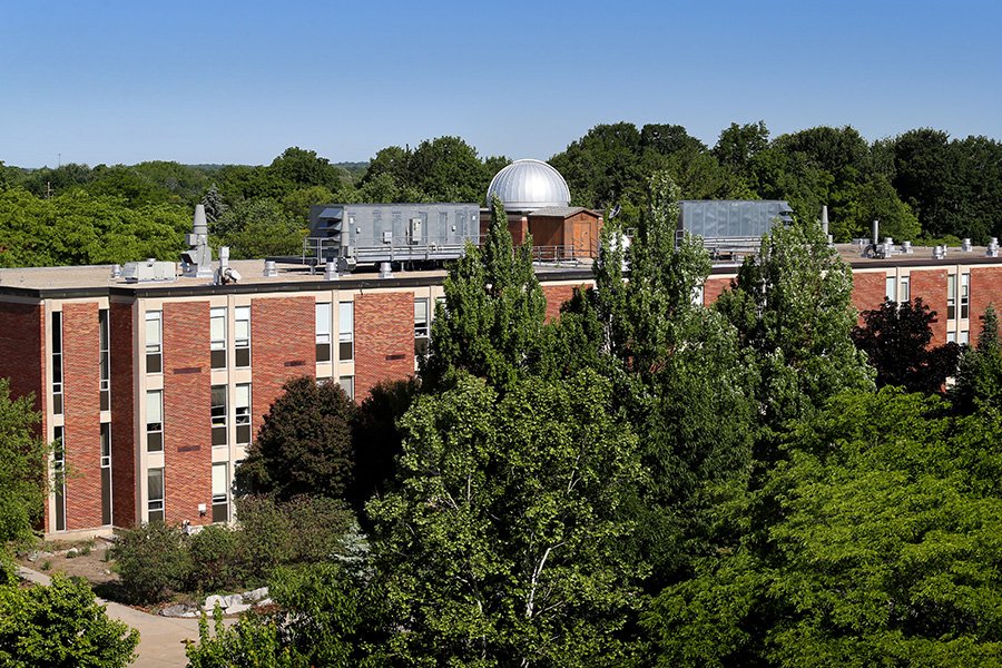 Brooks Astronomical Observatory, a silver-domed building, can be seen over the treetops on campus.