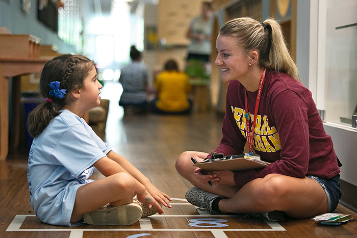 Speech-language pathology student working with a young student during the Summer Speech-Language Specialty Clinics.