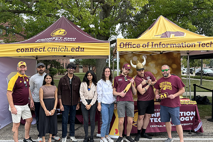 Group photo of nine staff in front of our tents.