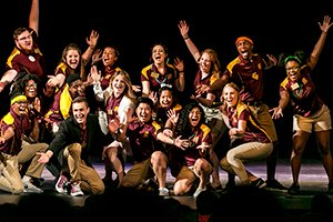 Student orientation guides pose on stage