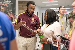 Student talks with mentor at orientation