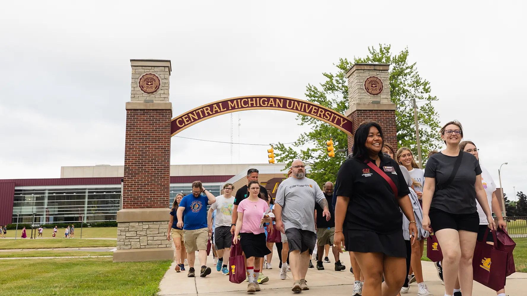 outdoor tour group walking under the CMU arch