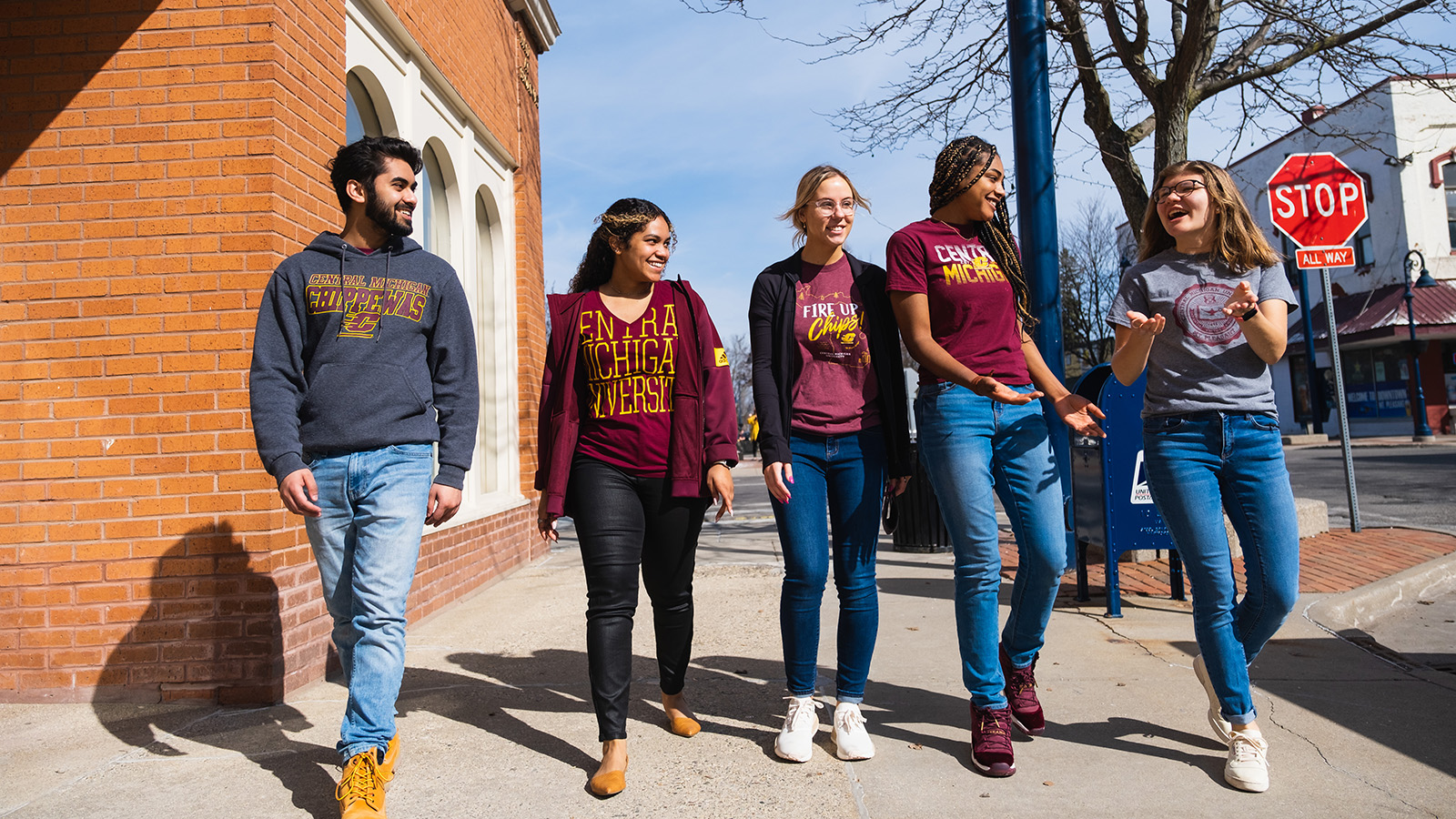 A group of CMU students walk down the sidewalk in downtown Mt. Pleasant.