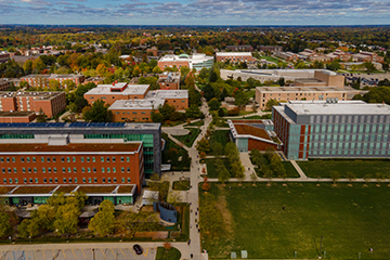 A group of buildings and trees from above.