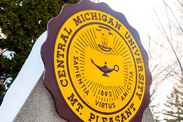 A maroon and gold sign reading Central Michigan University