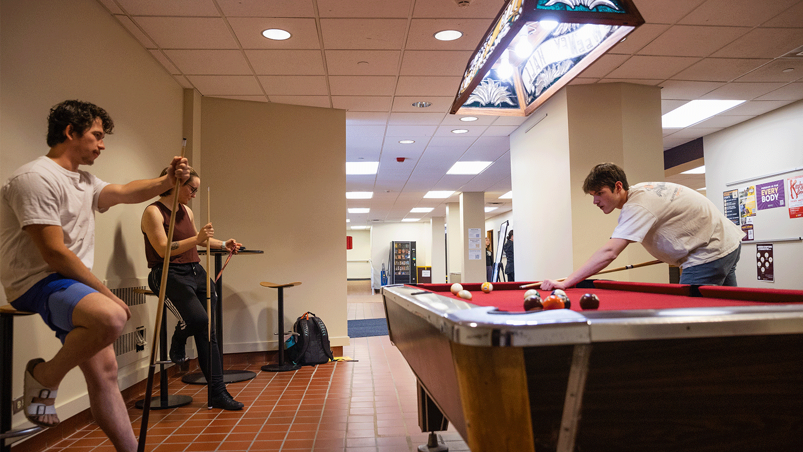 living learning communities pool table Three students standing around a pool table and playing pool while chatting in a residence hall at Central Michigan University.