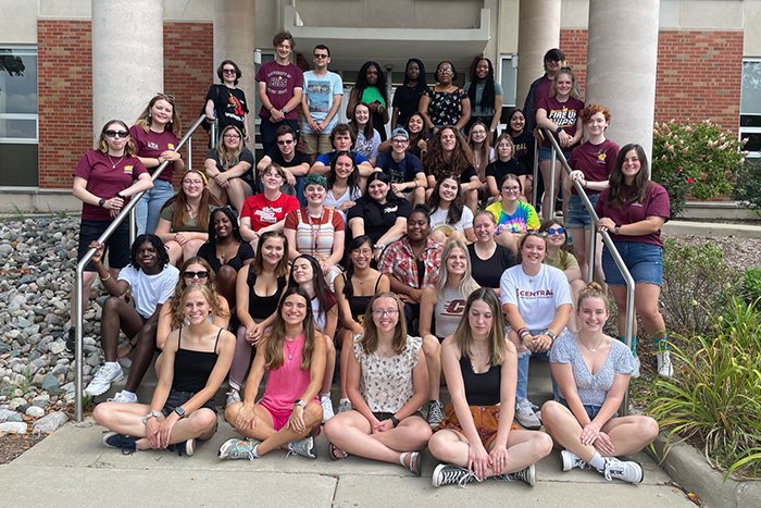 Group shot of Public Service Residential College students sitting outside on stairs.