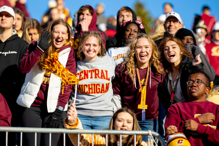 a group of people posing for a photo at a football game