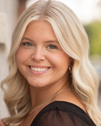 A woman with blonde hair smiling at the camera.