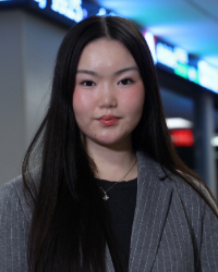 a woman with long hair wearing a suit jacket
