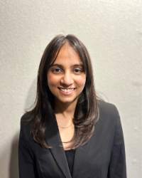 Headshot of Pratichee in a black suit