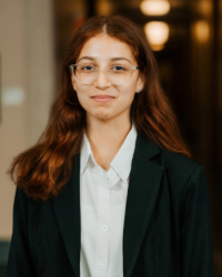 A woman in a suit and glasses.