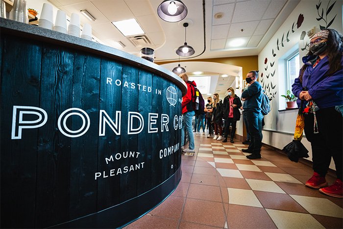 A close up of the coffee counter for Ponder Coffee. Students wait in line to order.