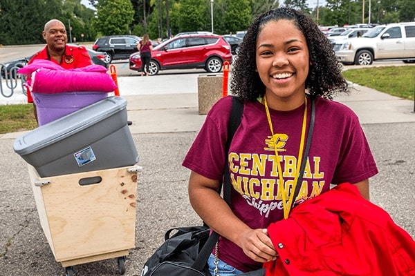 parent and student moving bins on move in day