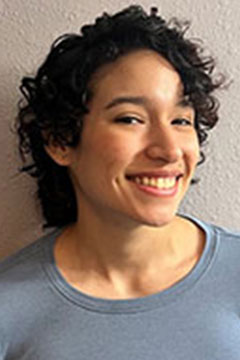 A headshot of SI Assistant Program Supervisor, Mark Rodriguez, posing in front of a white wall.