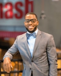 Headshot of LaMarcus Howard in a gray suit, blue undershirt, and bowtie.