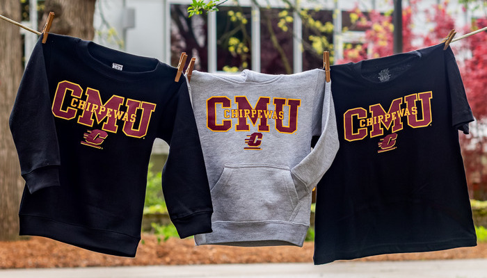 alumni_bookstore_700x400 Three CMU clothing items, each saying CMU Chippewas with the Action C, hanging on a clothesline outdoors.