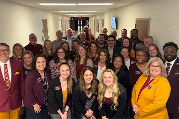 The Central Michigan University Alumni Association Board of Directors pose for a group photo during a May 2025 gathering.